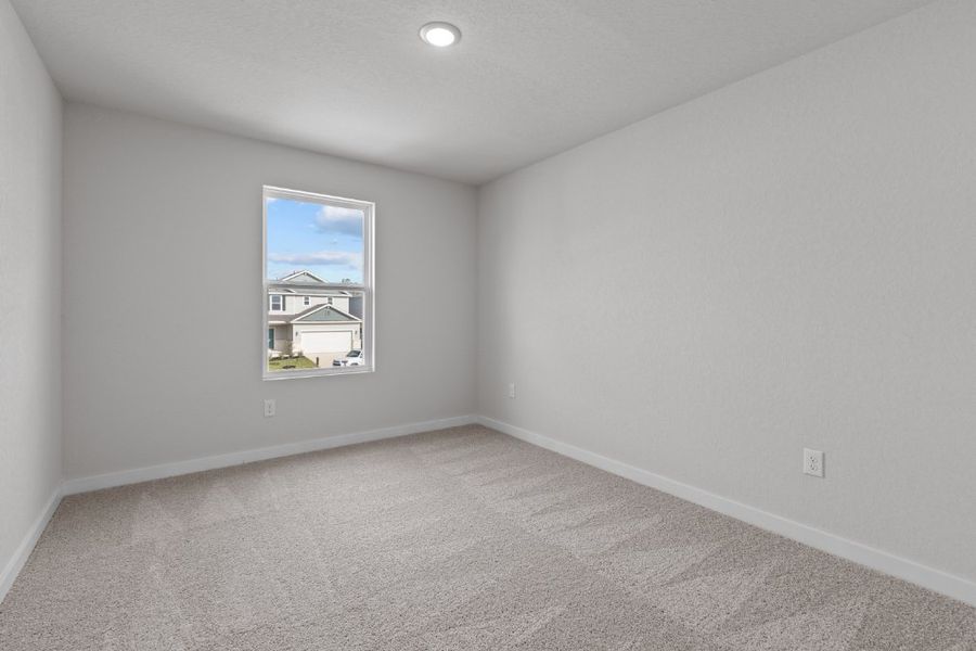 A room with a window and a carpet. A room with a window and a carpet.