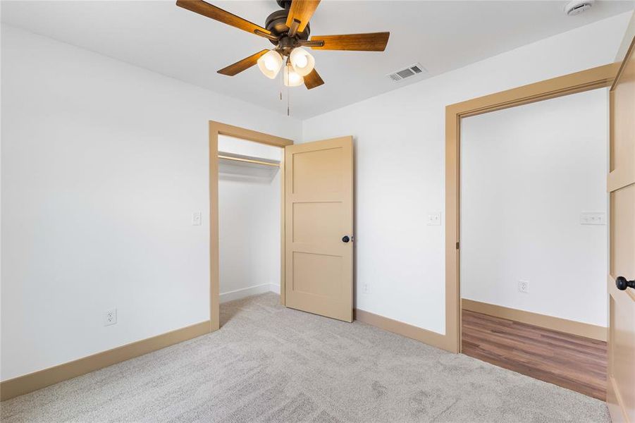 Unfurnished bedroom with carpet floors and a ceiling fan