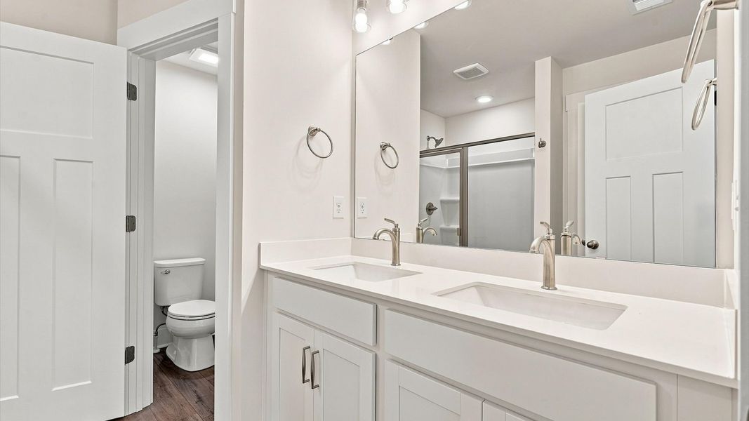 Accomplished design shines in this primary bath with dual vanity and a sleek walk-in shower in Spartanburg, SC Accomplished design shines in this primary bath with dual vanity and a sleek walk-in shower in Spartanburg, SC