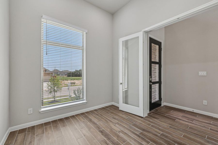 Empty room with dark wood finished floors and baseboards Empty room with dark wood finished floors and baseboards