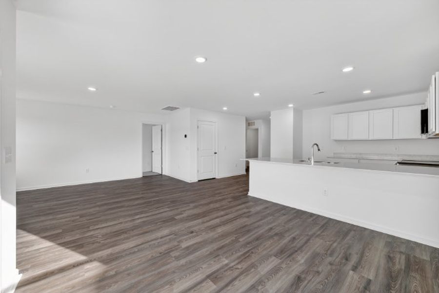 A kitchen with white cabinets.