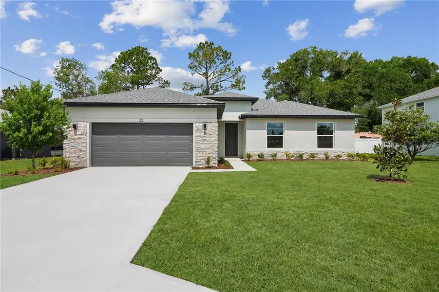 Front exterior of a new home in Palm Coast, Palm Coast, FL, highlighting curb appeal (Image 2). Front exterior of a new home in Palm Coast, Palm Coast, FL, highlighting curb appeal (Image 2).