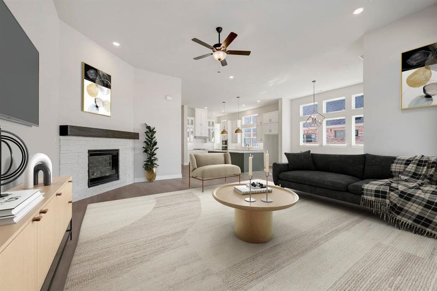 Living room with wood finished floors, a ceiling fan, a fireplace, and recessed lighting