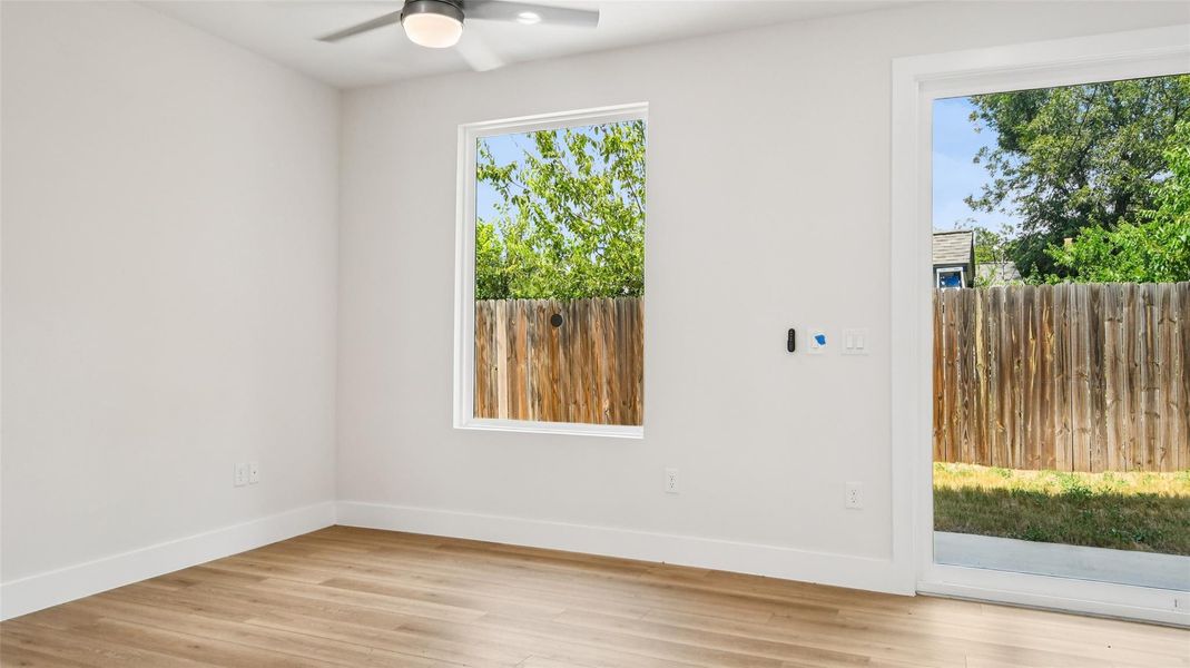 Unfurnished room featuring light wood-type flooring and ceiling fan Unfurnished room featuring light wood-type flooring and ceiling fan