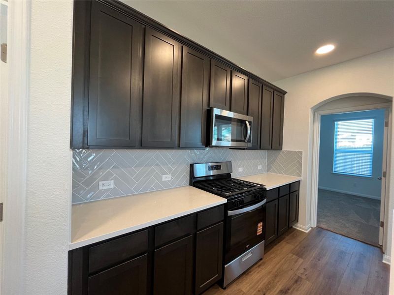 42" cabinets, Whirlpool vented microwave, dishwasher and gas range.