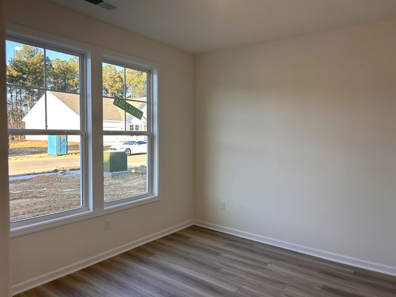 Unfurnished room with baseboards and wood finished floors