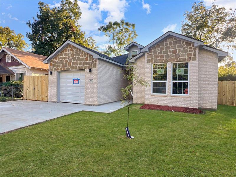 View of front property with a front yard and a garage