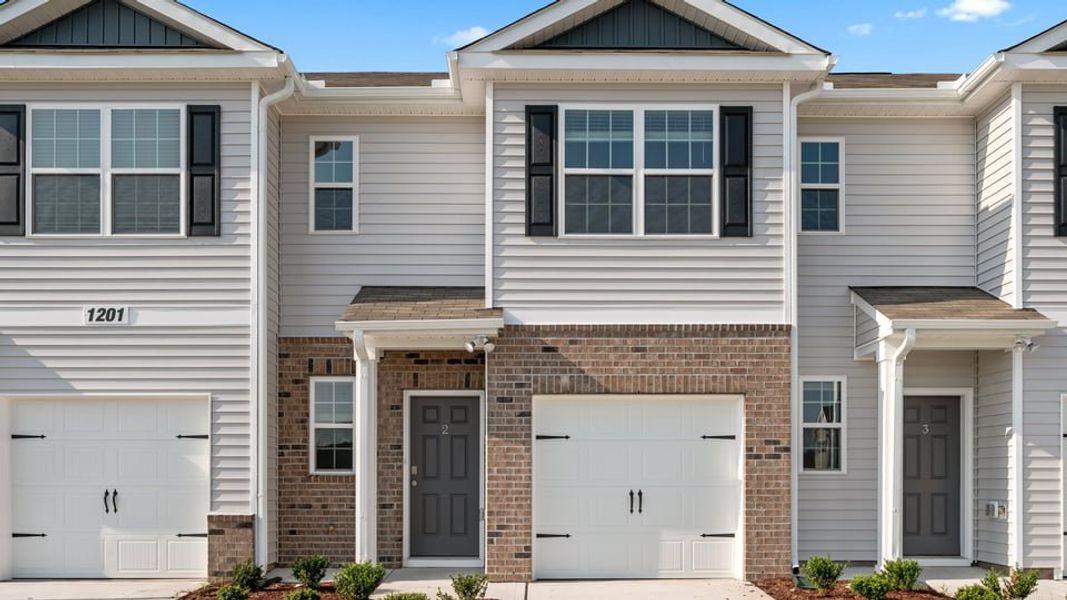 Front exterior of a new home in North Village Townes, Greensboro, NC, highlighting curb appeal (Image 1). Front exterior of a new home in North Village Townes, Greensboro, NC, highlighting curb appeal (Image 1).
