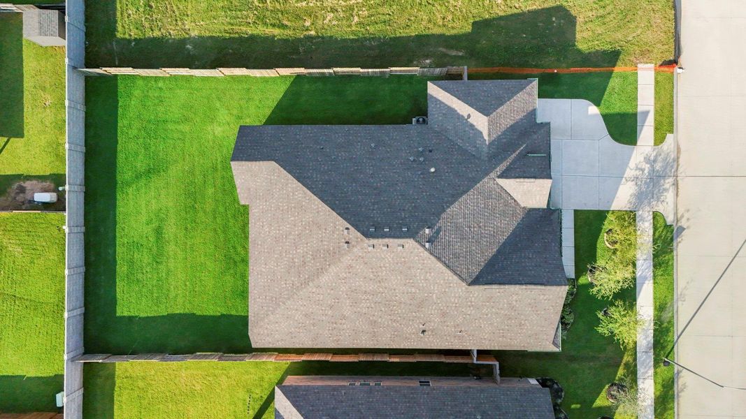 Overhead lot view displaying the generous yard space, driveway, and home layout in relation to the property.