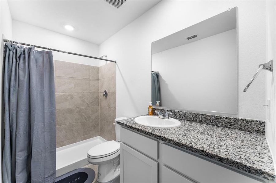 Bathroom featuring vanity and a shower stall Bathroom featuring vanity and a shower stall