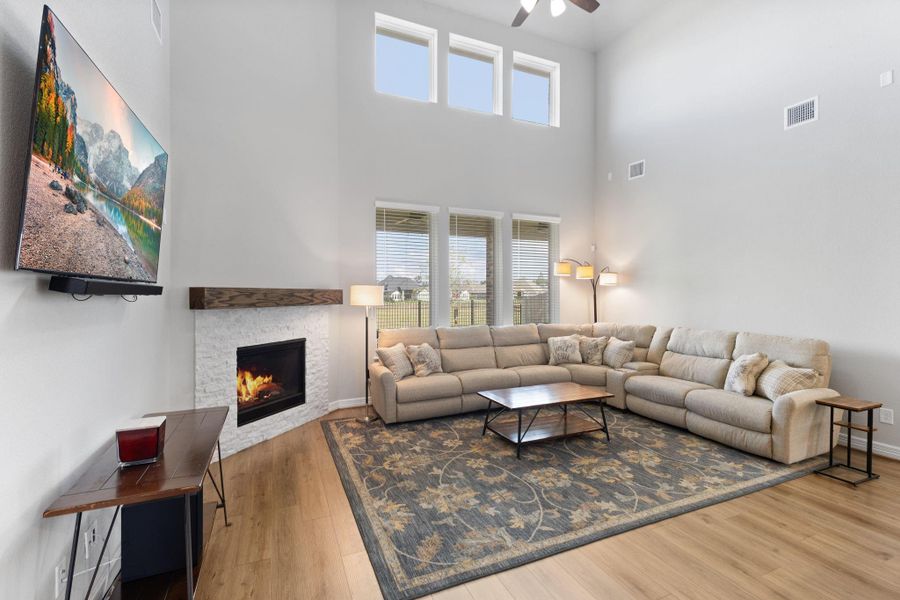 Gas log fireplace and large windows for natural lighting and great views of the private backyard.