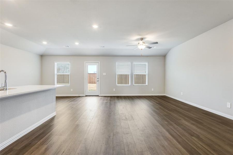 Unfurnished living room with dark wood-style flooring, recessed lighting, and ceiling fan