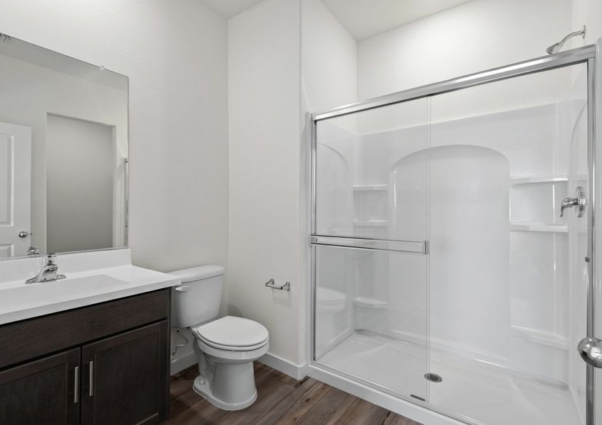 The master bathroom has a beautiful glass-enclosed shower.