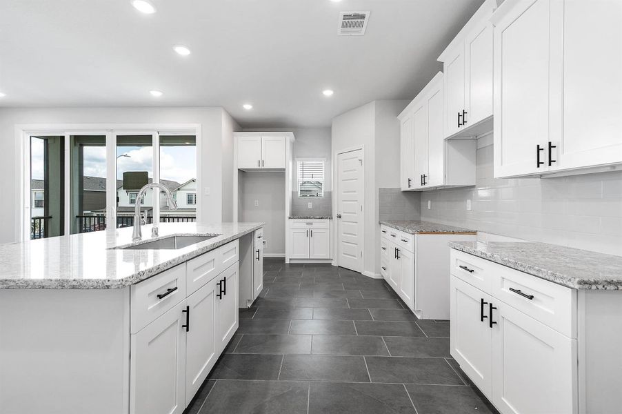 Kitchen featuring plenty of countertop space. Kitchen featuring plenty of countertop space.