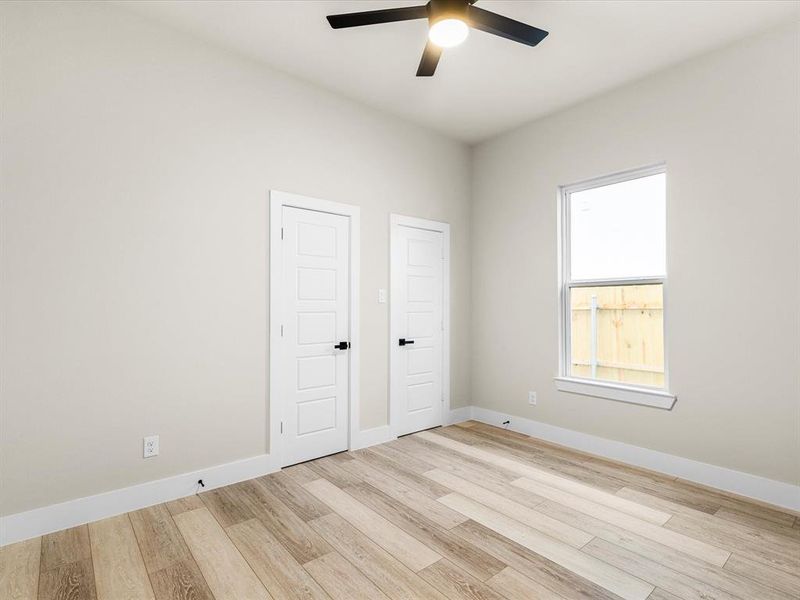 Unfurnished bedroom with light wood-style flooring and a ceiling fan