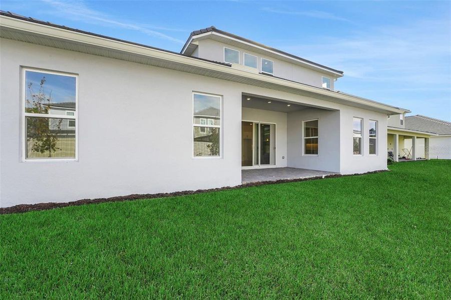 Exterior details and patio area of a home in Palms at Windermere, Windermere (Image 24).