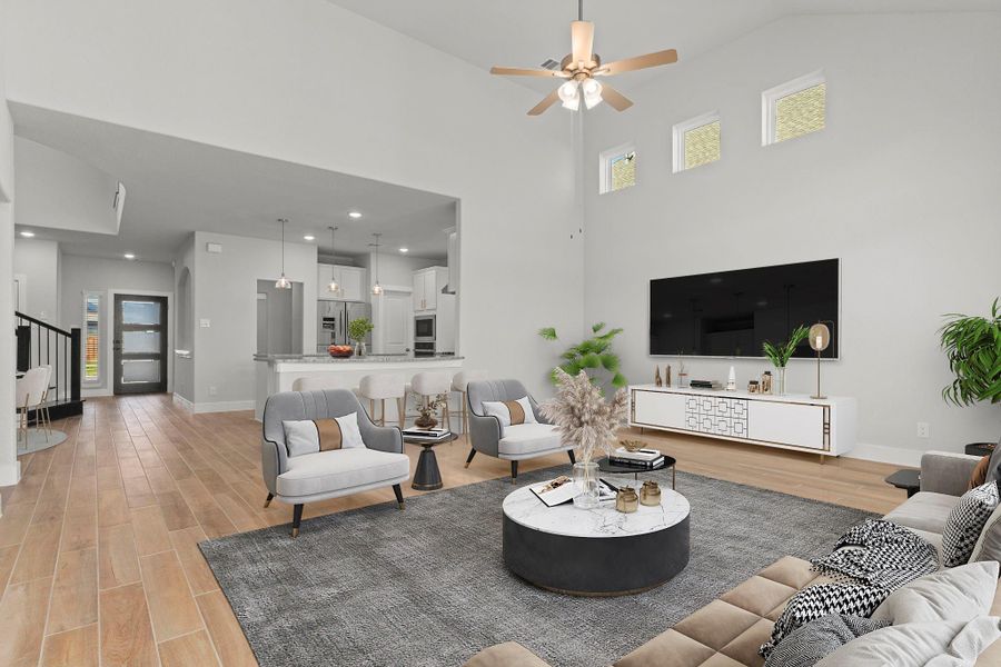 Expansive and inviting, this large family area is the ultimate gathering space. Wood-look tile floors and soft neutral tones enhance the home’s warm, modern appeal while providing durability for everyday living. *Photo Staged* Expansive and inviting, this large family area is the ultimate gathering space. Wood-look tile floors and soft neutral tones enhance the home’s warm, modern appeal while providing durability for everyday living. *Photo Staged*