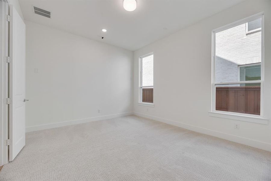 Empty room featuring light carpet and recessed lighting