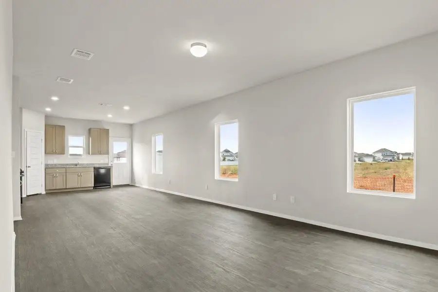 Living room open to kitchen representative photo