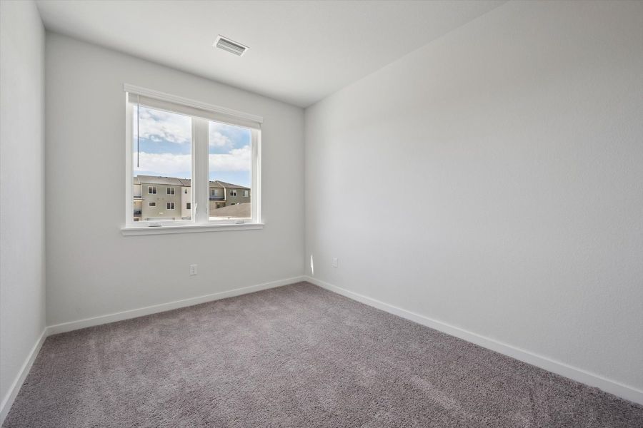 A room with a window and a carpet. A room with a window and a carpet.