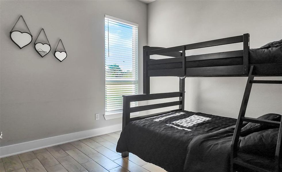 Bedroom featuring baseboards and light wood-type flooring