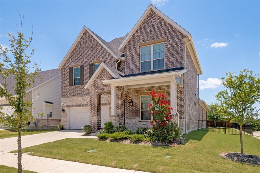 Front exterior of a new home in Bayside, Rowlett, TX, highlighting curb appeal (Image 2). Front exterior of a new home in Bayside, Rowlett, TX, highlighting curb appeal (Image 2).