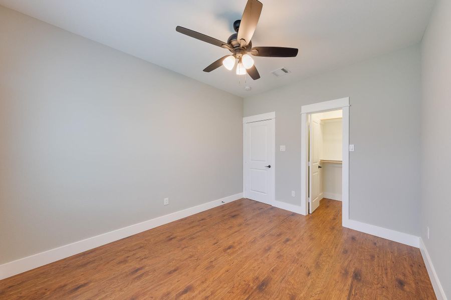 Second bedroom featuring a spacious walk-in closet, offering ample storage and a comfortable, organized living space.