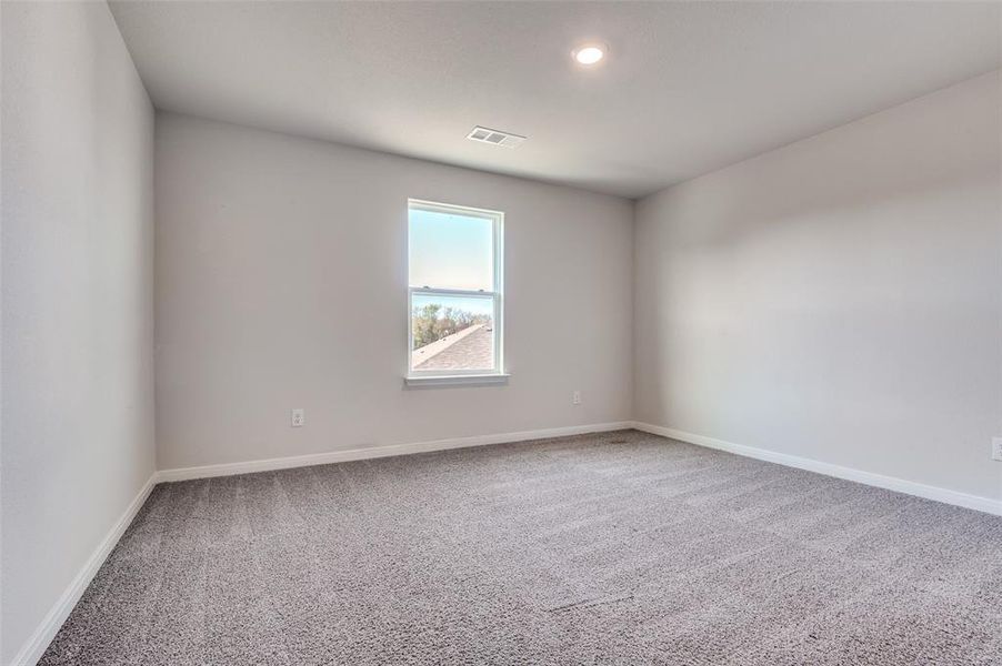 Unfurnished room with light colored carpet and baseboards