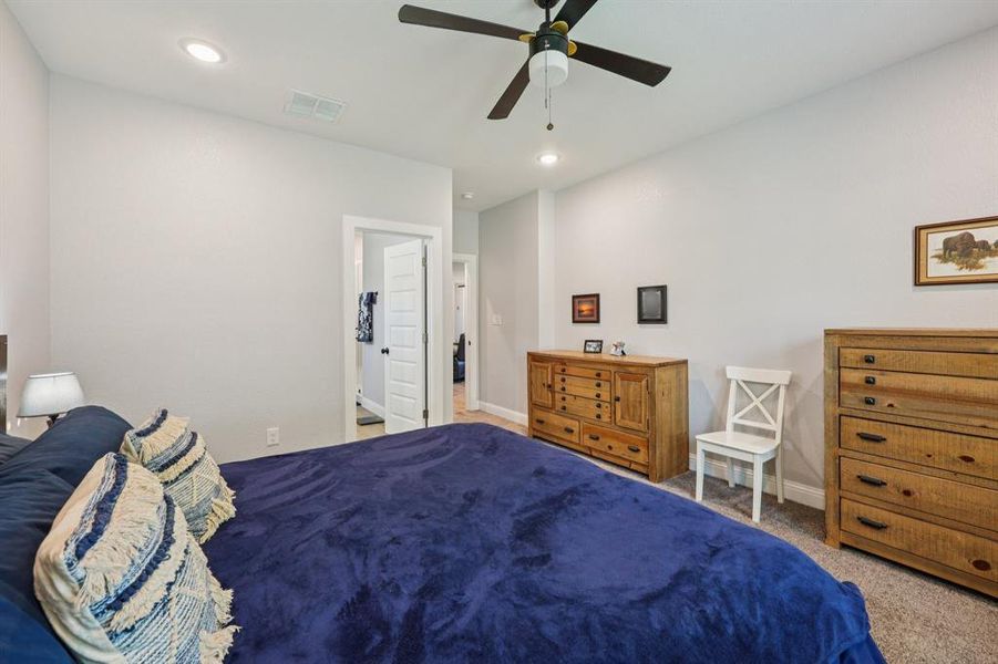Bedroom with carpet flooring, a ceiling fan, and recessed lighting Bedroom with carpet flooring, a ceiling fan, and recessed lighting