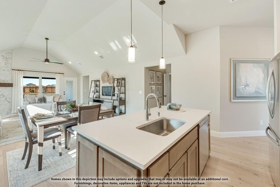 Kitchen island with sink and pendant lights, open to dining and living areas with vaulted ceiling and hardwood floors Kitchen island with sink and pendant lights, open to dining and living areas with vaulted ceiling and hardwood floors