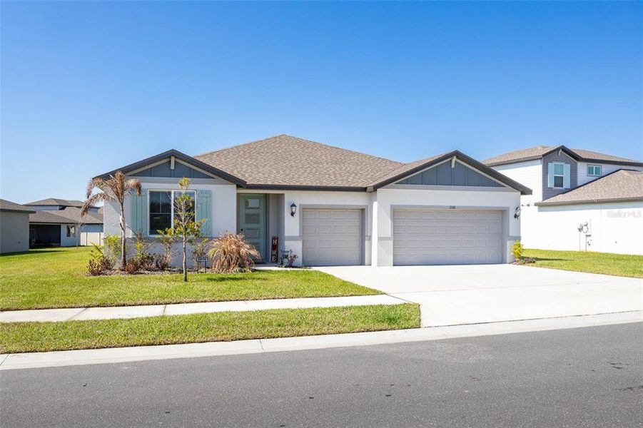 Front exterior of a new home in The Grove at Stuart Crossing - Signature Series, Bartow, FL, highlighting curb appeal (Image 1). Front exterior of a new home in The Grove at Stuart Crossing - Signature Series, Bartow, FL, highlighting curb appeal (Image 1).