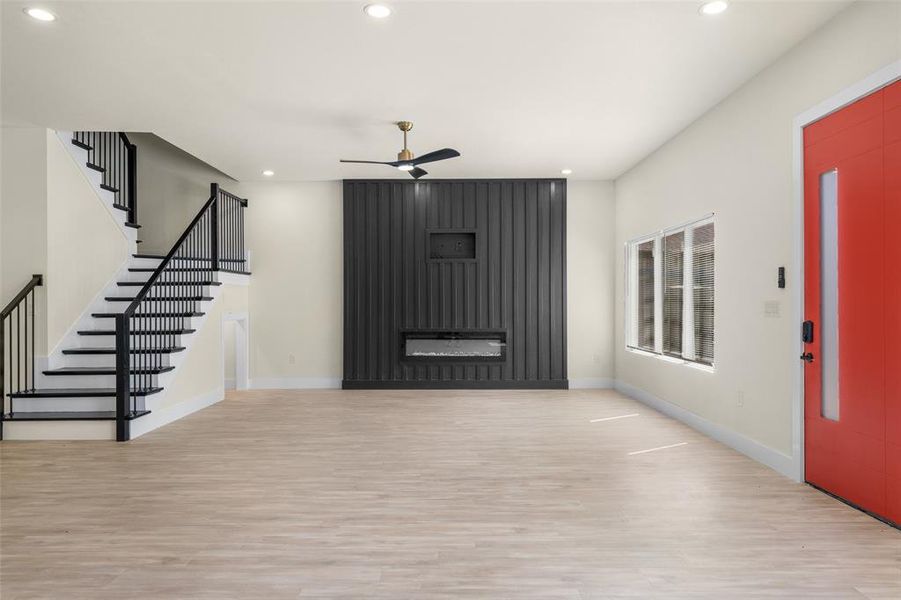 Foyer with a ceiling fan, recessed lighting, light wood-type flooring, stairway, and elevator