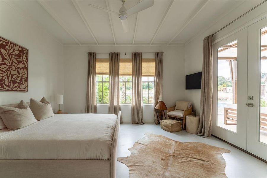 Bedroom with french doors, beamed ceiling, access to exterior, ceiling fan, and carpet flooring Bedroom with french doors, beamed ceiling, access to exterior, ceiling fan, and carpet flooring