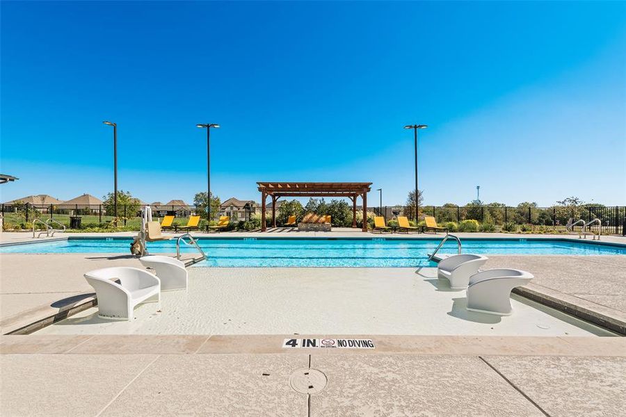 Community pool with a patio, a pergola, and a residential view Community pool with a patio, a pergola, and a residential view