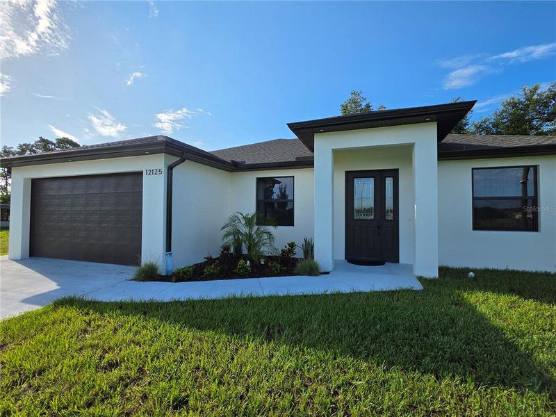 Front exterior of a new home in , North Port, FL, highlighting curb appeal (Image 1). Front exterior of a new home in , North Port, FL, highlighting curb appeal (Image 1).