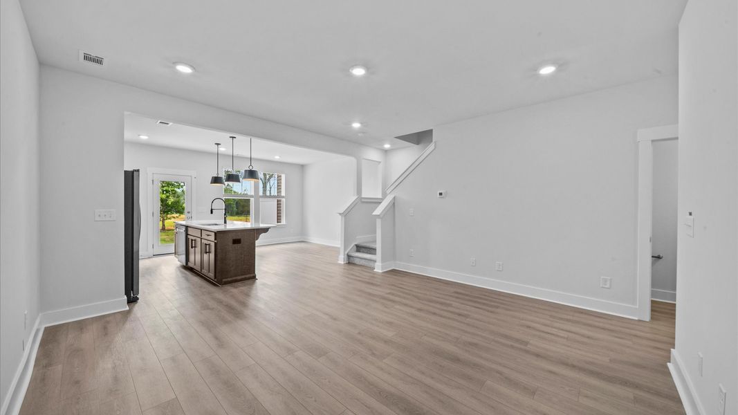 Open concept family room with hardwood flooring in two story townhome at Ransdell Pointe by DRB Homes in Spartanburg, SC