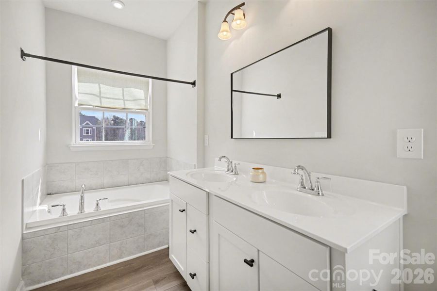 Primary bathroom soaking tub, and large window providing natural light