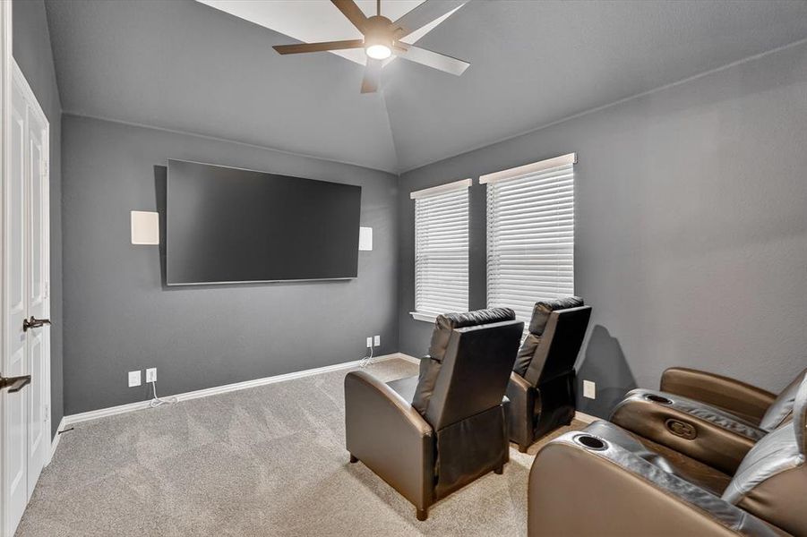 Media room featuring a wall-mounted display, recessed lighting, and a ceiling fan Media room featuring a wall-mounted display, recessed lighting, and a ceiling fan