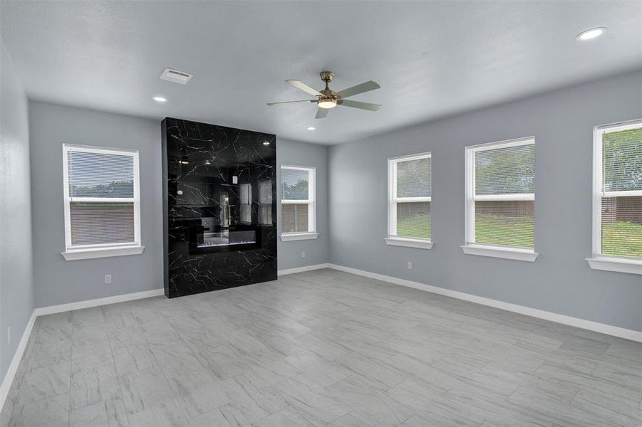 Unfurnished living room with a ceiling fan and recessed lighting