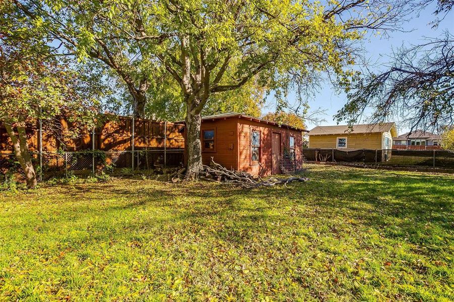 Large backyard with mature trees.