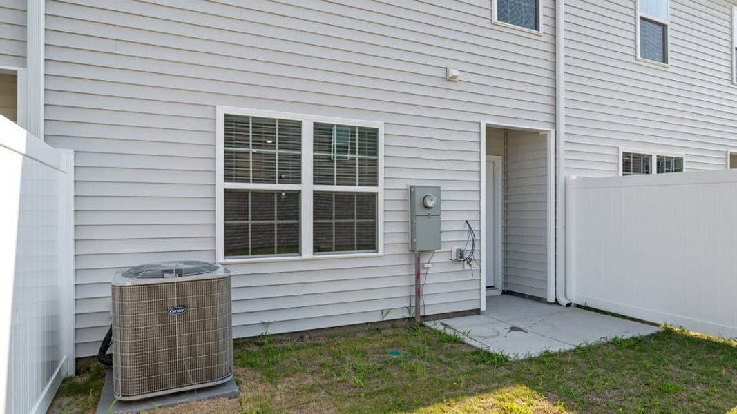 Exterior details and patio area of a home in The Townes at Ridgewood Farms, Winterville (Image 20).