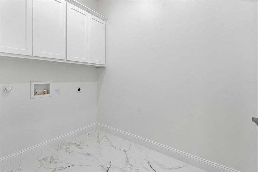 Laundry area featuring hookup for a washing machine, electric dryer hookup, cabinets, and hookup for a gas dryer