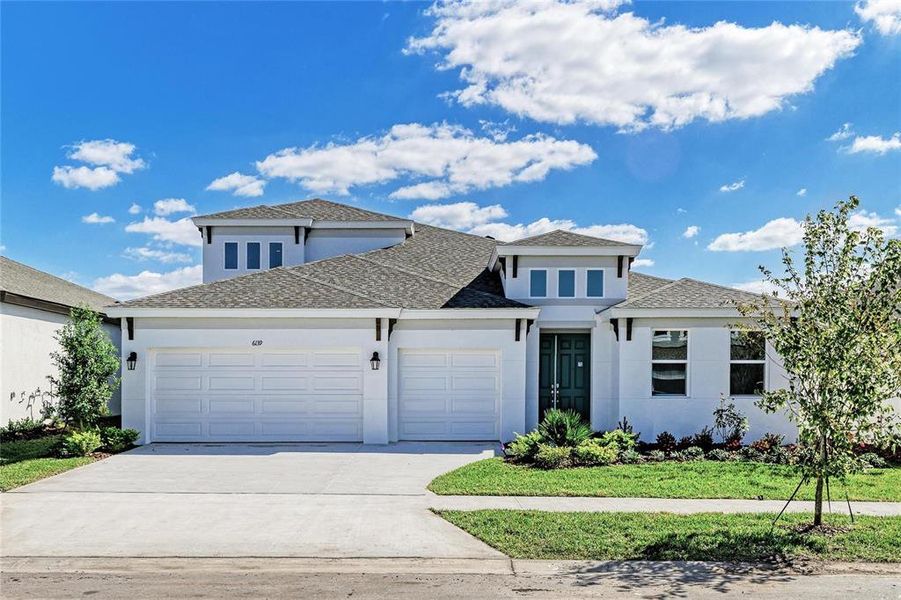 Front exterior of a new home in Waterset, Apollo Beach, FL, highlighting curb appeal (Image 1).