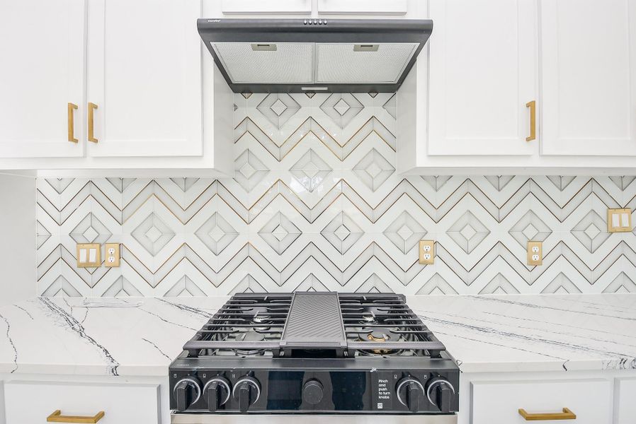 This gourmet kitchen features a gas cooktop with a vented hood and a sleek single oven, perfect for any home chef. This gourmet kitchen features a gas cooktop with a vented hood and a sleek single oven, perfect for any home chef.