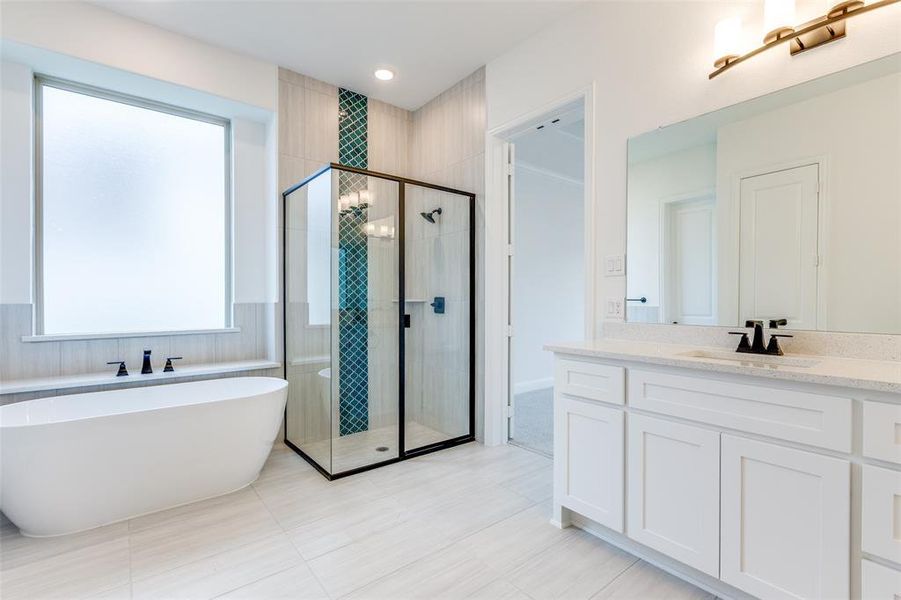 Soaking tub and large window.