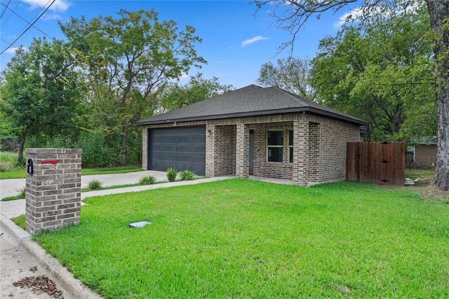 View of front of house featuring brick siding, a front lawn, concrete driveway, and a shingled roof View of front of house featuring brick siding, a front lawn, concrete driveway, and a shingled roof