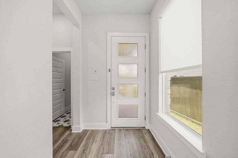 Welcoming entry foyer with high ceilings, durable flooring, and elegant natural light. Welcoming entry foyer with high ceilings, durable flooring, and elegant natural light.
