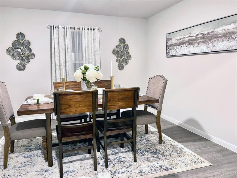 Dining space with baseboards and wood finished floors Dining space with baseboards and wood finished floors