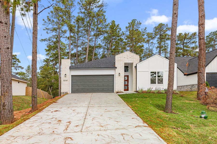 Front exterior of a new home in , Conroe, TX, highlighting curb appeal (Image 24). Front exterior of a new home in , Conroe, TX, highlighting curb appeal (Image 24).