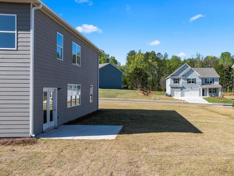 Front exterior of a new home in Thompson Ridge, Dallas, GA, highlighting curb appeal (Image 1).